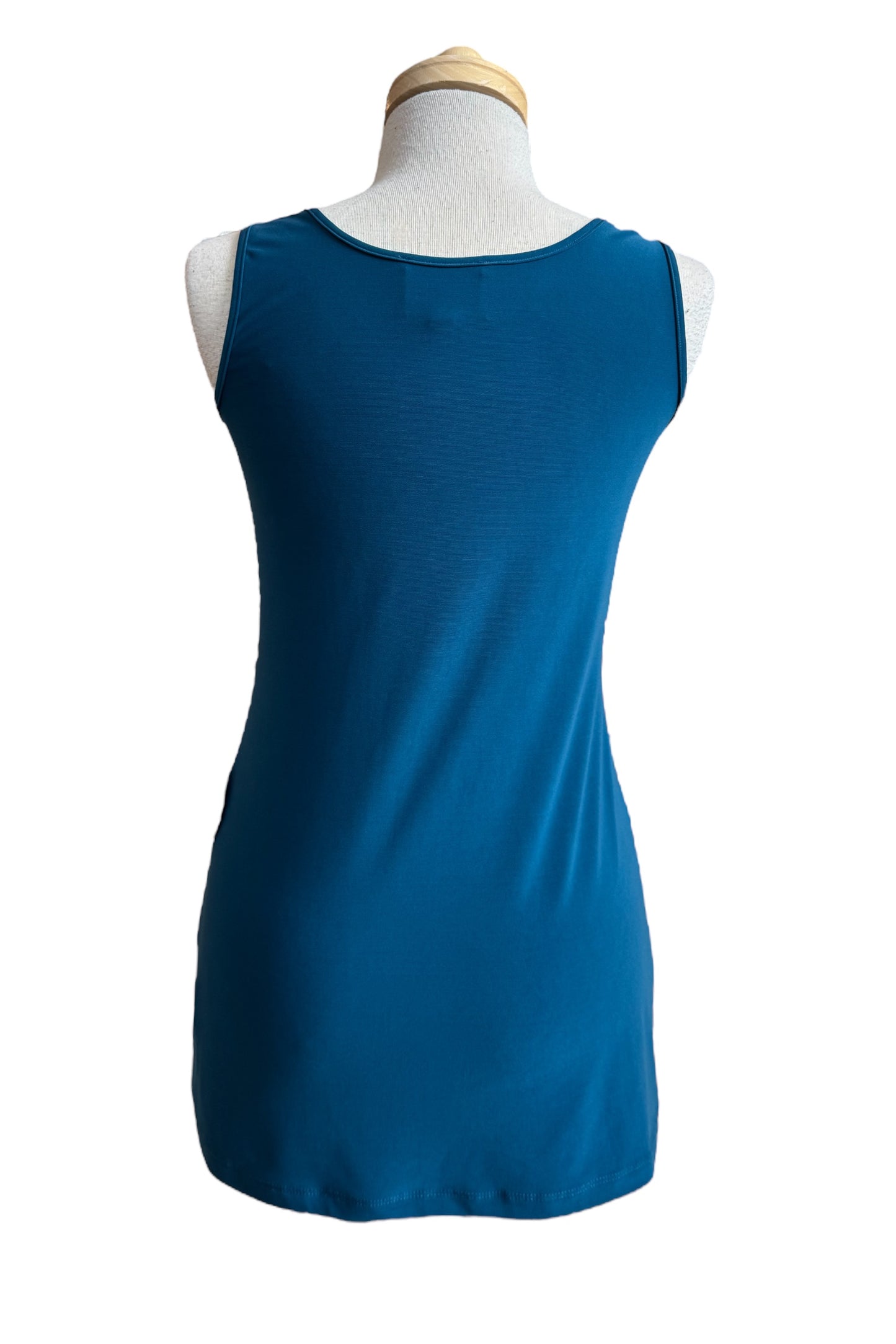A back view of the Parker Tank Top by Compli K in Teal, a long tank with wide straps and a scoop neck, is shown on a mannequin against a white background.