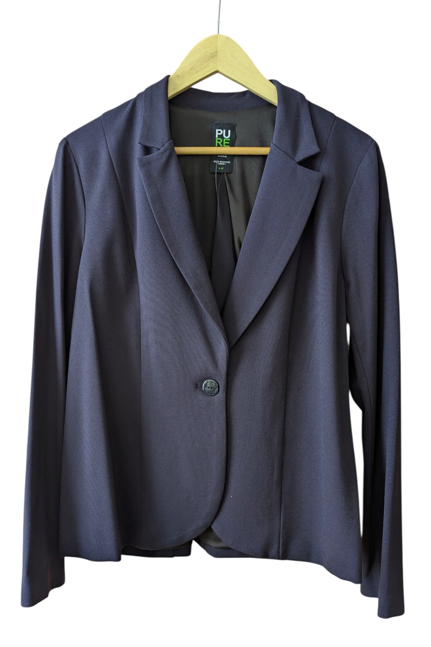 The Famke Jacket by Pure Essence in in Navy, a single breasted blazer with a single button closure, is shown hanging on a wall in front a white background.