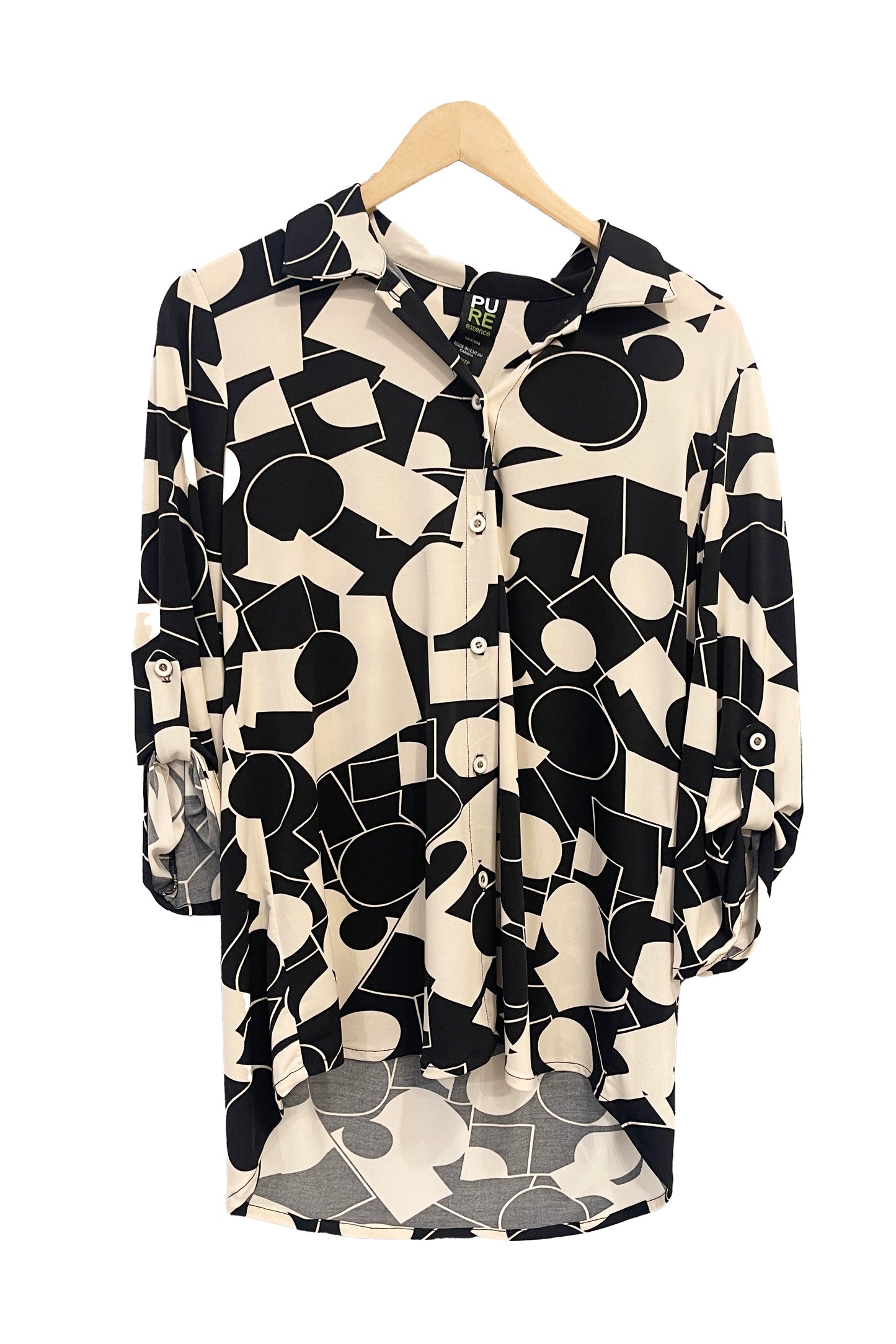 The Francesca Blouse by Pure in Black/Ivory geometric print, an oversized blouse with a lapel collar, button front, 3/4 sleeves with button and tab detail, and rounded h-low hemline, is shown hanging against a white background.