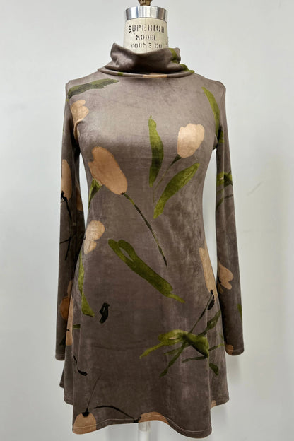 The Holly Tunic by Kollontai in Taupe, an Italian velvet A-line tunic with a turtleneck, long sleeves, and a floral print, is shown on a mannequin against a  a grey background. 