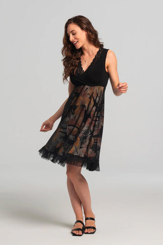 Levana Dress by Kollontai, black top with wrap-over neckline and lace trim, sleeveless, empire waist, A-line skirt with tropical print under a black mesh layer, ruffled hem, knee length, sizes XS to XXL, made in Quebec