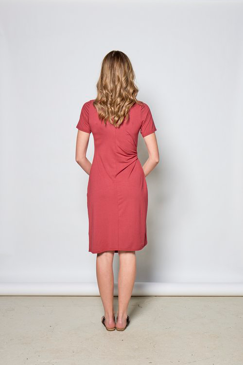Rachelle Dress by Tangente, Lipstick, back view, short sleeves, asymmetrical front hem, diagonal front seam, draping built-in ties, knee-length, anti-pill jersey, sizes XS to XXL, made in Ottawa