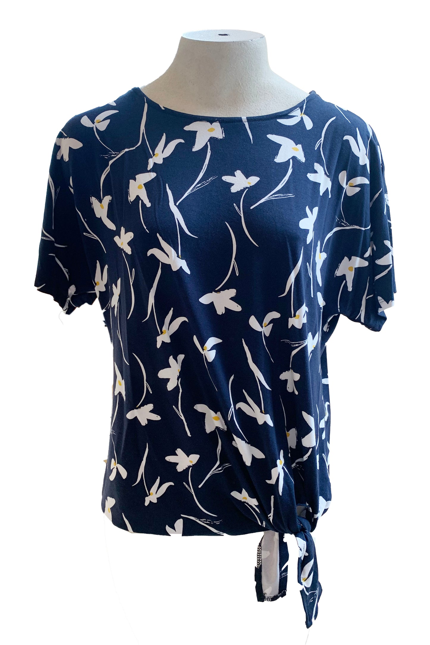 The Carter Top by Pure Essence in Navy with a white floral print is shown on a mannequin against a white background 