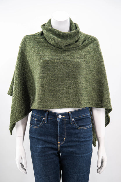 The winter Poncho by Karkass in Green, with a large turtleneck and angled hem, is shown on a mannequin against a white background