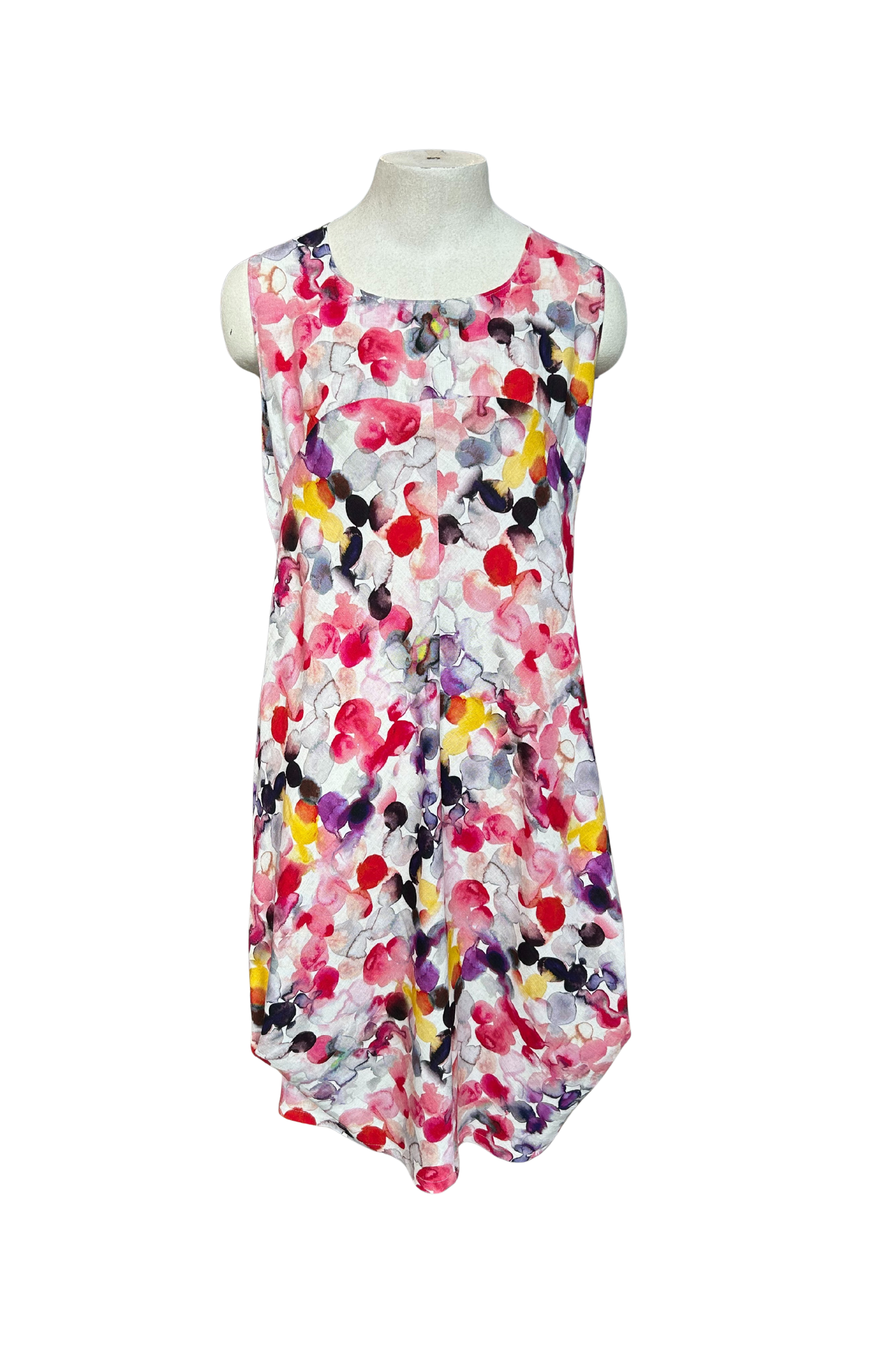 The Monica Dress by Solomia in Watercolour Print is shown on a mannequin against a white background. It's a sleeveless knee-length dress with a relaxed fit and uniquely angled bottom hem. 