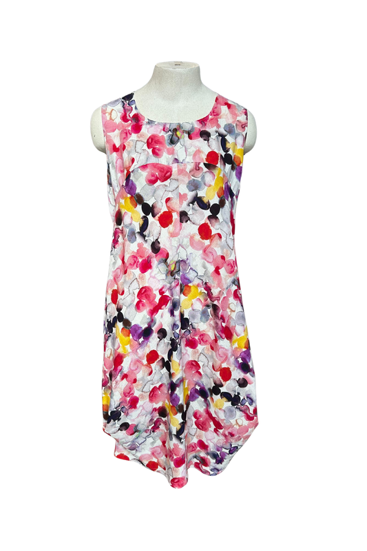 The Monica Dress by Solomia in Watercolour Print is shown on a mannequin against a white background. It's a sleeveless knee-length dress with a relaxed fit and uniquely angled bottom hem. 