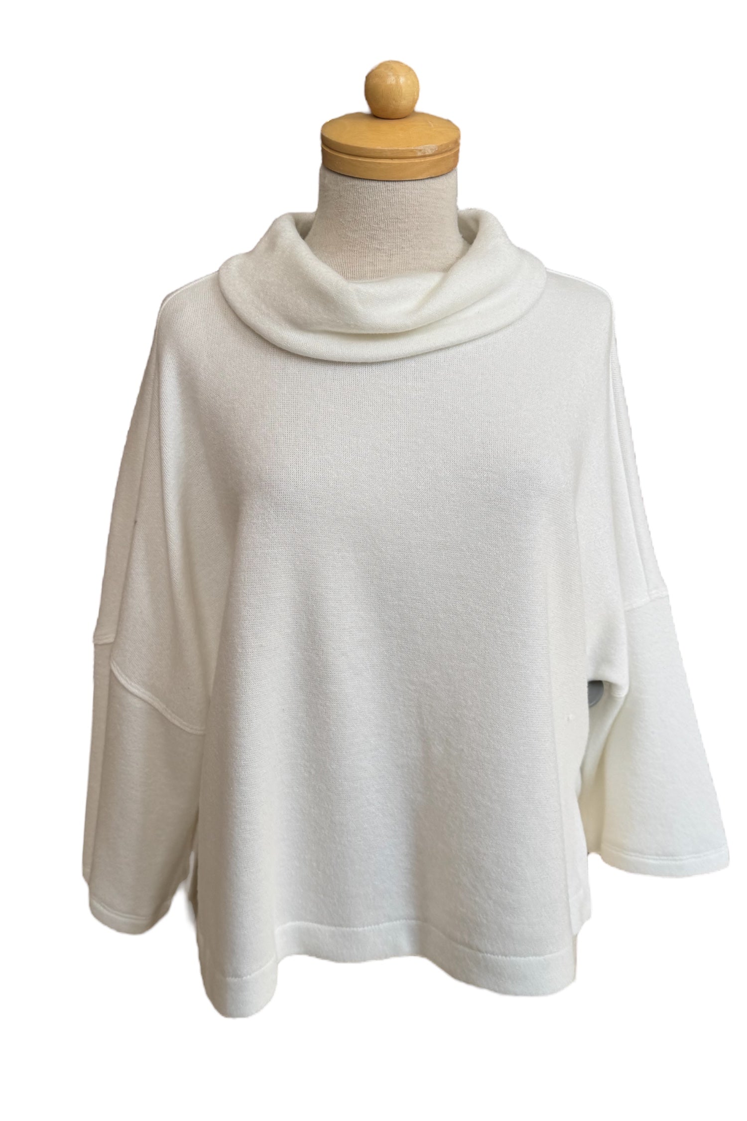 The Paige Sweater by Compli K in Off-White, featuring a large cowl neck, drop-sleeves, a loose fit, and side slits, is shown on a mannequin against a white background. 