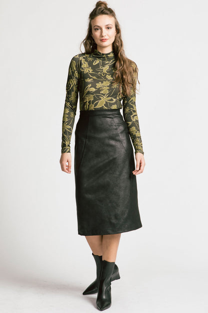 A woman wearing the Graduate Skirt by Allison Wonderland in black Leatherette, a slim midi-length pencil skirt in faux leather with a two-way zipper at the back. She is wearing it with the Rebecca Turtleneck and standing in front of a white background. 