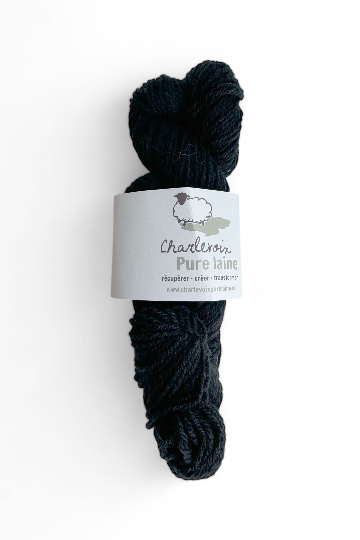 A skein of Black yarn from Charlevoix Pure Laine is shown against a white background 