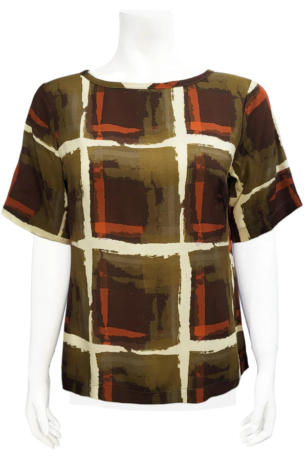 The Cecil Box Blouse by Mandala in Cubist print is shown on a mannequin against a white background. It has a high neckline, wide 1/2 sleeves, and a side hem slit detail. 