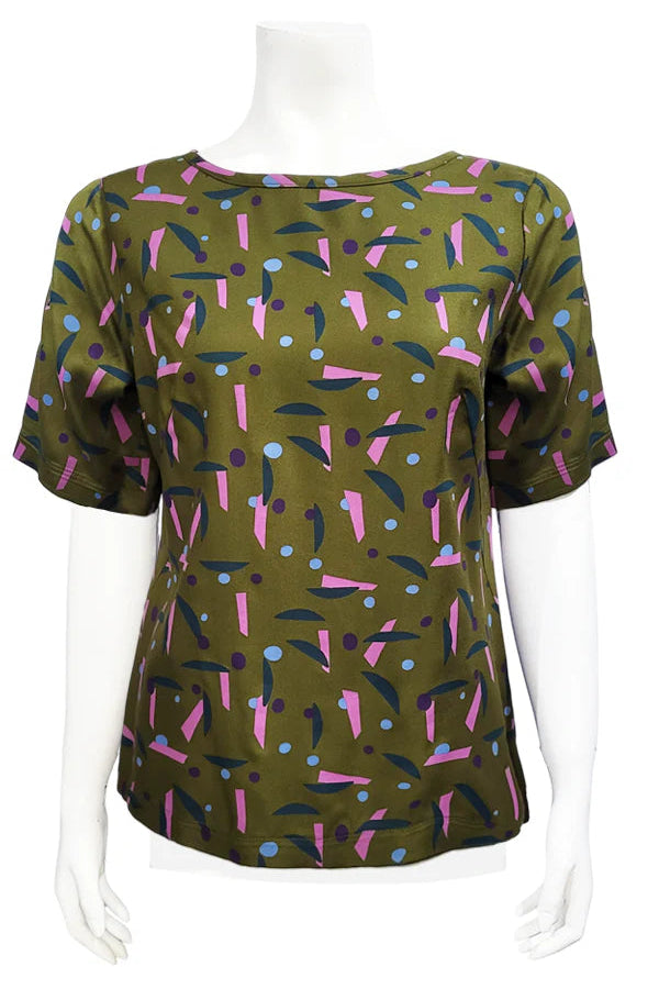 The Cecil Box Blouse by Mandala in Playtime Ivy print is shown on a mannequin against a white background. It has a high neckline, wide 1/2 sleeves, and a side hem slit detail. 