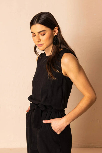 Brume Jumpsuit by Cherry Bobin, Black, side view, sleeveless, high front neckline, cutout and tie detail at back neckline, elastic waist, tie belt, invisible back zipper, eco-fabric, rayon and linen, sizes XS to XL, made in Montreal 