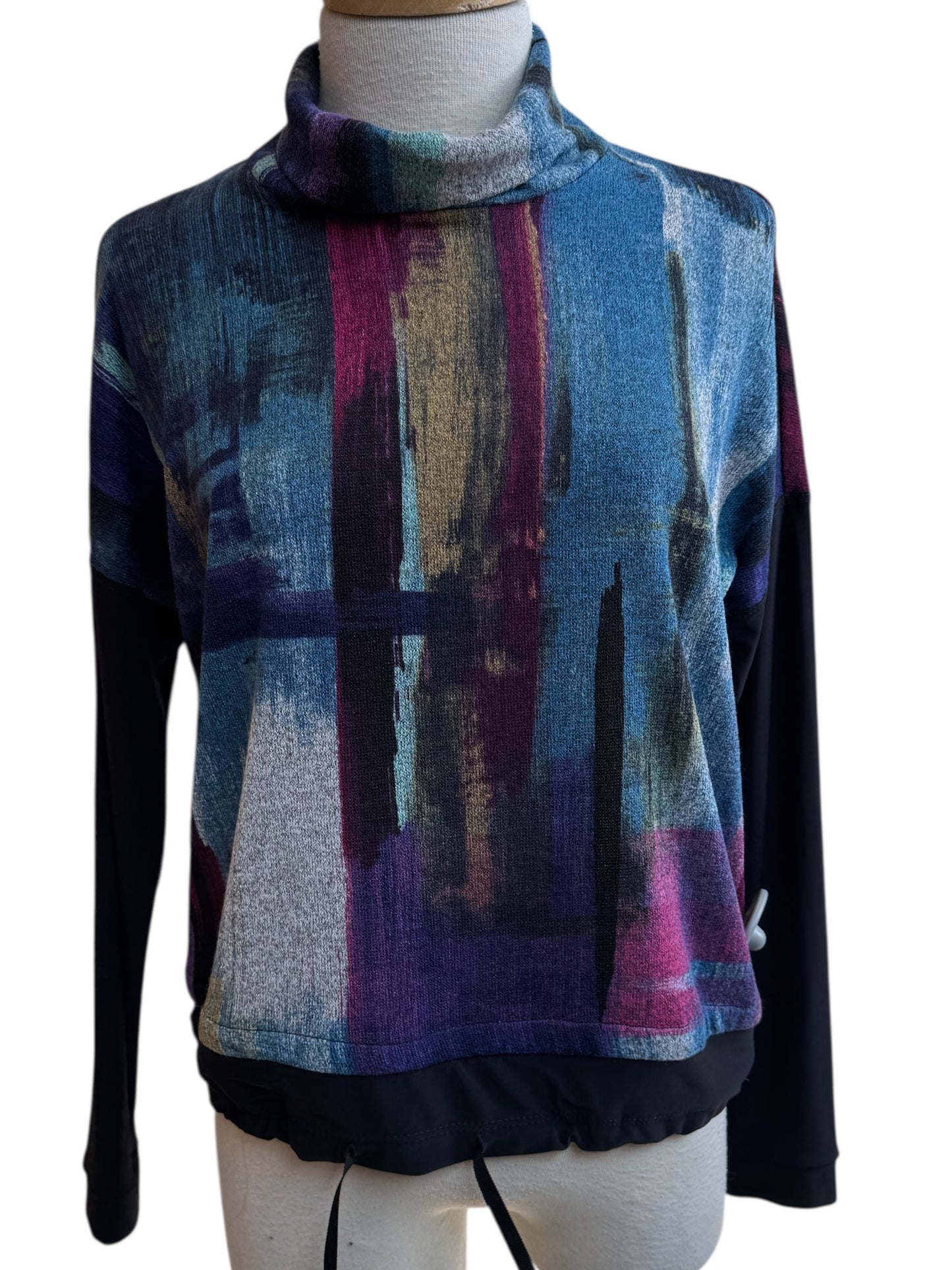 The Payton Top by Compli K in Blue and Berry Abstract print, with a turtleneck, drop sleeves, and drawstring waist, is shown on a mannequin in front of a white background. 