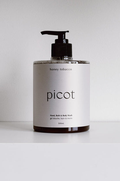 A bottle of Picot Honey Tobacco Body Wash on a white background. 