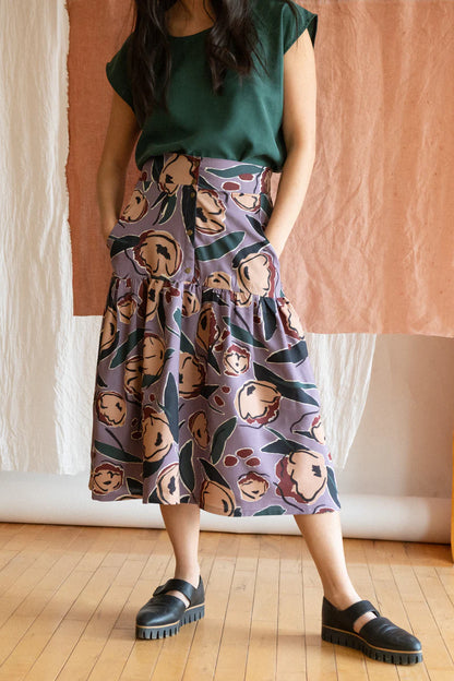 Campanule Skirt by Kazak, Lilac Peony, midi-length, tiered skirt, elastic at back of waist, brass buttons, two pockets, eco-fabric, viscose, OEKO-TEX certified, sizes XS to XL, made in Montreal 