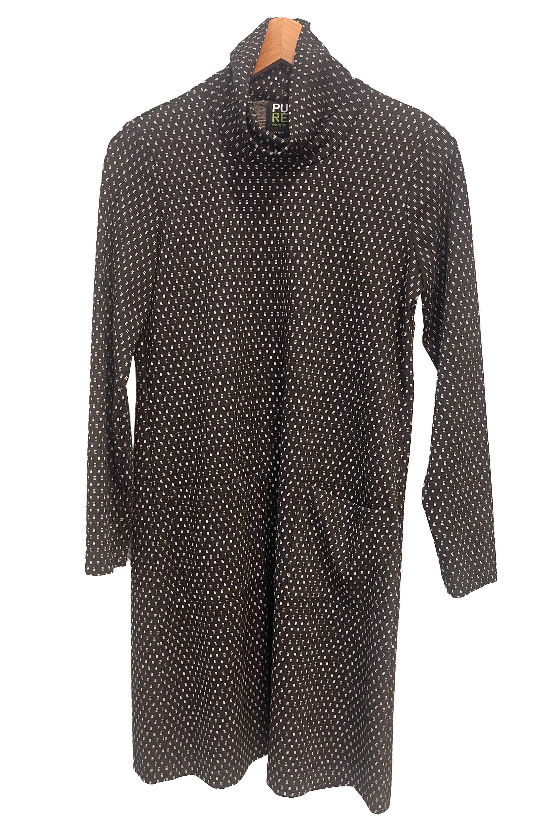 The Floella Dress by Pure Essence in Black/Ivory/ featuring a turtleneck, long sleeves, a slight a-line shape that hits the knee, and front patch pockets, is shown hanging against a white background. 