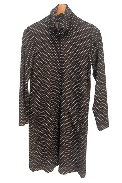 The Floella Dress by Pure Essence in Black/Ivory/ featuring a turtleneck, long sleeves, a slight a-line shape that hits the knee, and front patch pockets, is shown hanging against a white background. 