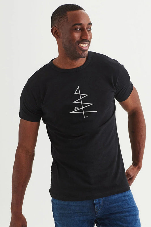 A man wearing the Sommet T-shirt by Message Factory in Black, a classic t-shirt with cycling-inspired graphic in white. He is wearing it with jeans and standing in front of a white background. 