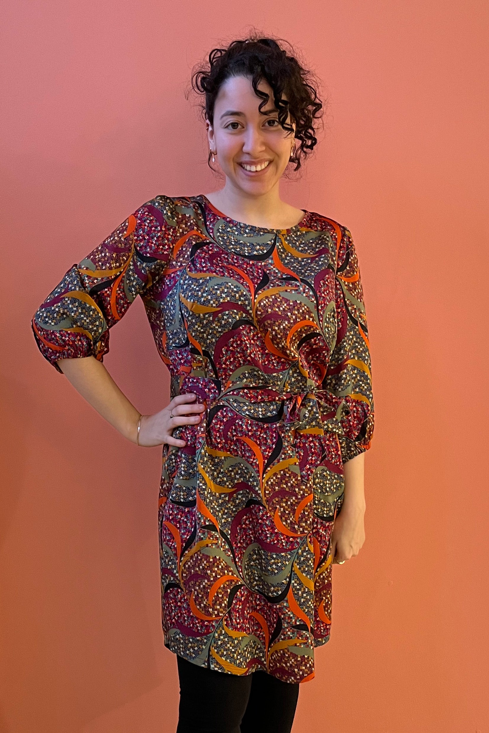 Shine Bloom Dress by Mandala, Spice, abstract print, jewel neck, 3/4 sleeves with gather and button detail, French darts, elastic at back waist, tie belt, scooped hem, sizes XS to XL, made in Ontario