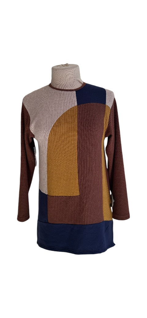 The Gladis Top by Solomia, featuring a colour-blocked front in Yellow/Cream/Blue/Brown and a solid Brown back, with a round neck and long sleeves, show on a mannequin in front of a white background. 