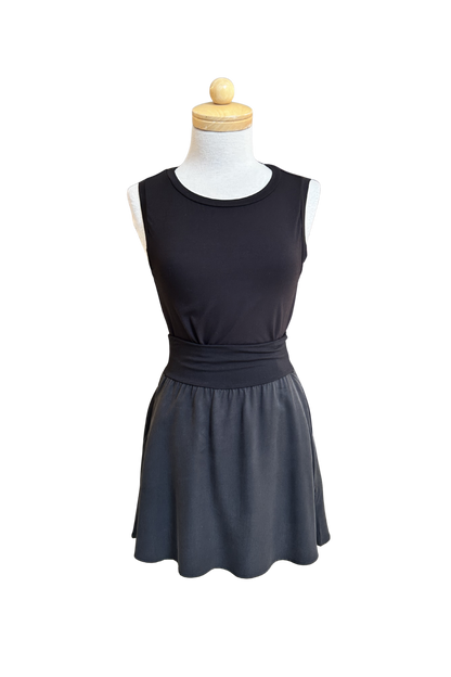 The Neon Camisole by Slak in Black, a high necked, wide strapped tank, is shown on a mannequin with a black skirt against a white background.