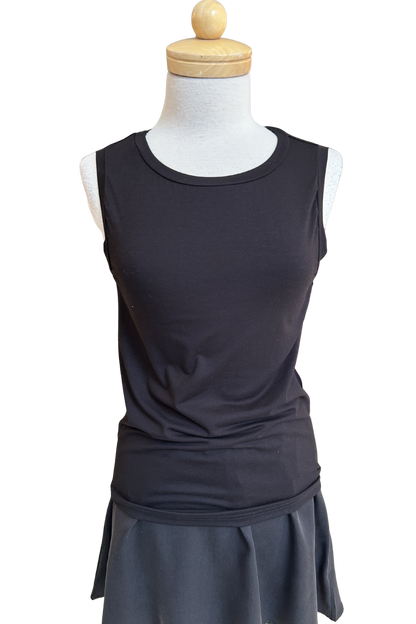 he Neon Camisole by Slak in Black, a high necked, wide strapped tank, is shown on a mannequin with a black skirt against a white background.