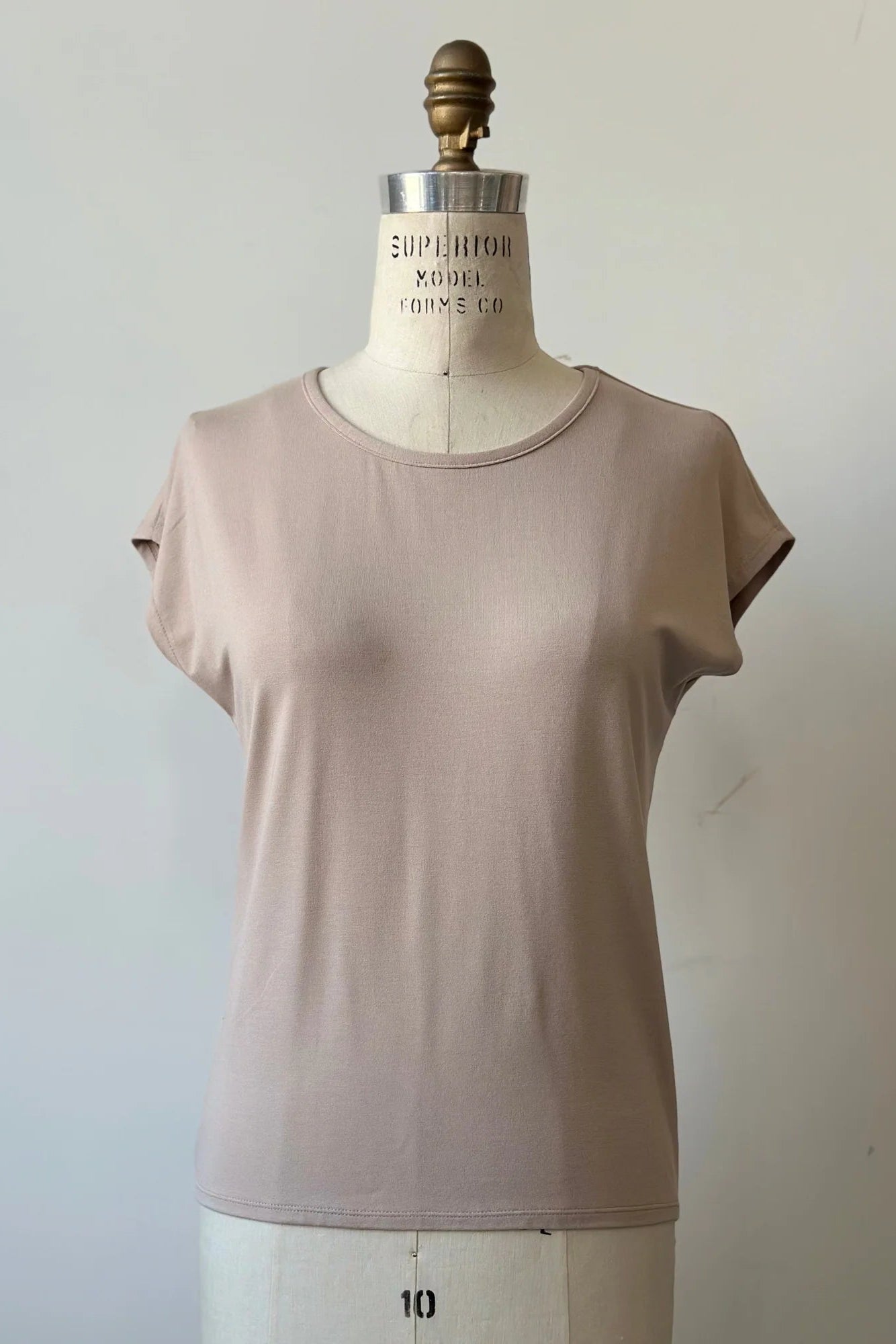 The Eowyn T-Shirt by Kollontai in Sand is shown on a white mannequin against a white background.