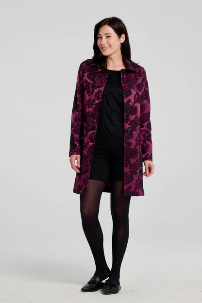 A woman wearing  the Amarante Coat by Kollontai