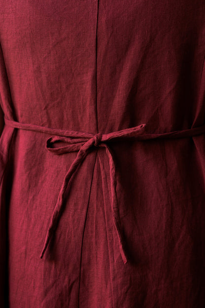 Close-up of waist tie of the Lights of All Astoria Dress in Garnet