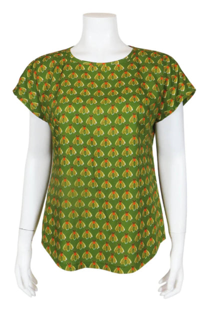 The Bea Blouse by Mandala in Fly Kiwi print is shown on a mannequin in front of a white background