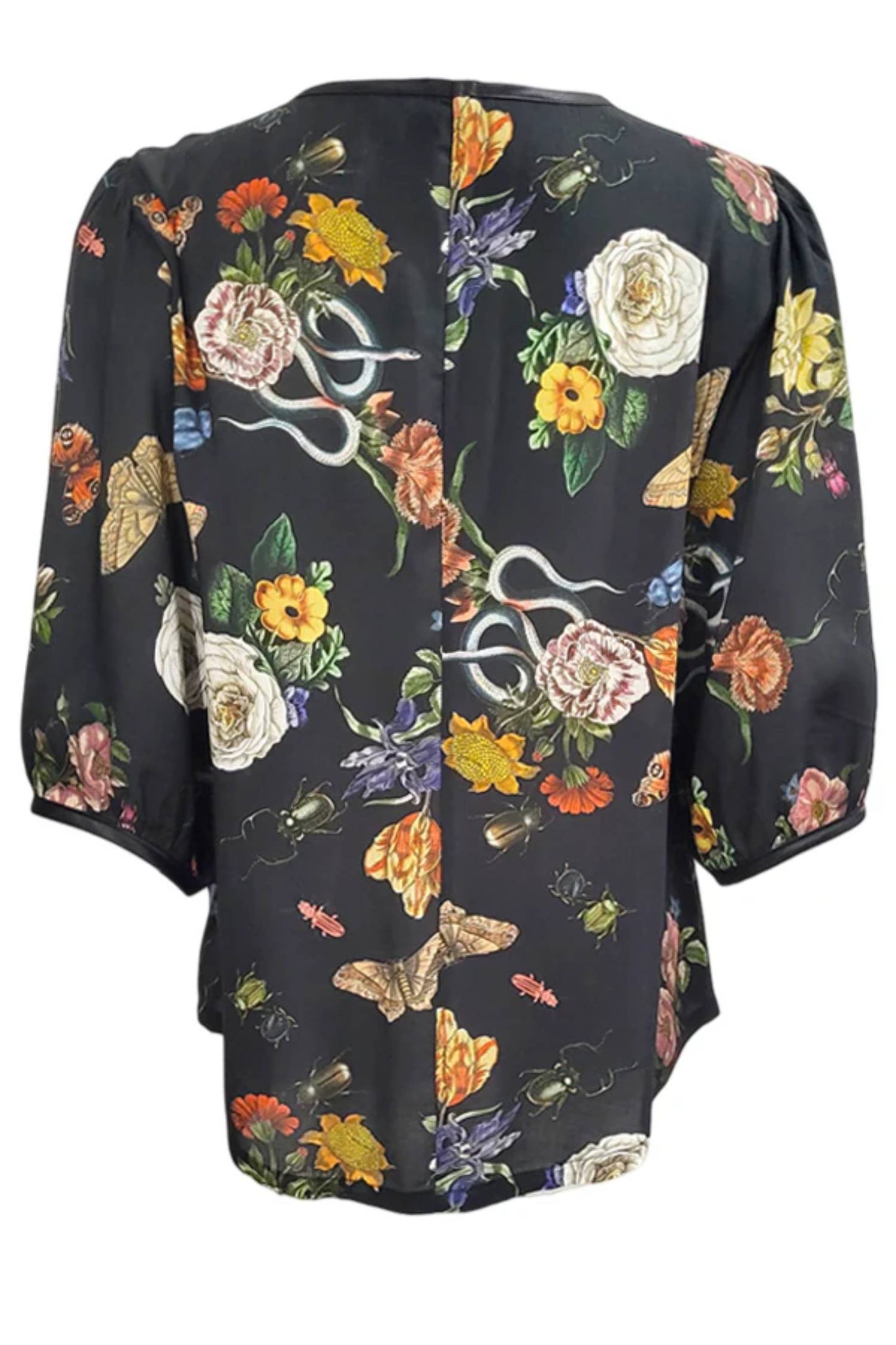 The back of the Lydia Creeper Blouse by Mandala in Onyx is shown in front of a white background. It features a vintage floral print with snakes and insects, with a jewel neck, puffed 3/4 sleeves, and a scooped hem. 