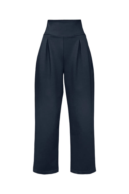 The Lionel Pants by Melow in Midnight (navy blue) full length trousers with a high elastic waistband, pressed front pleats, and side pockets, are shown in front of a white background. 