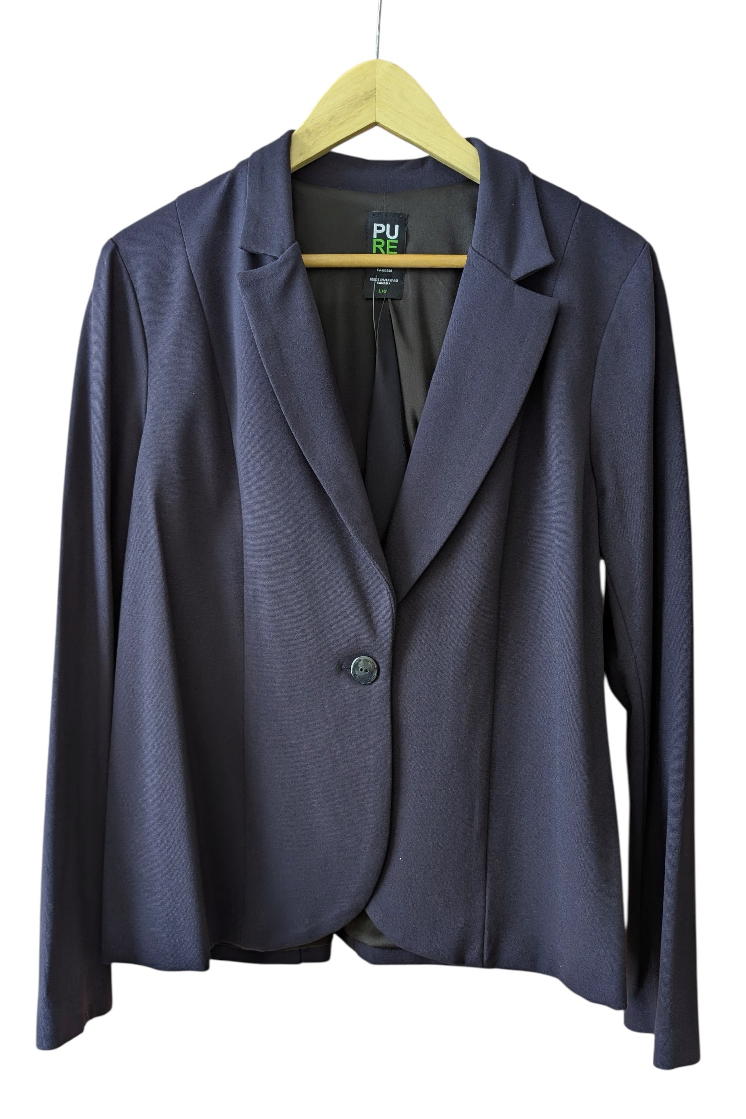 The Famke Jacket by Pure Essence in in Navy, a single breasted blazer with a single button closure, is shown hanging on a wall in front a white background. 