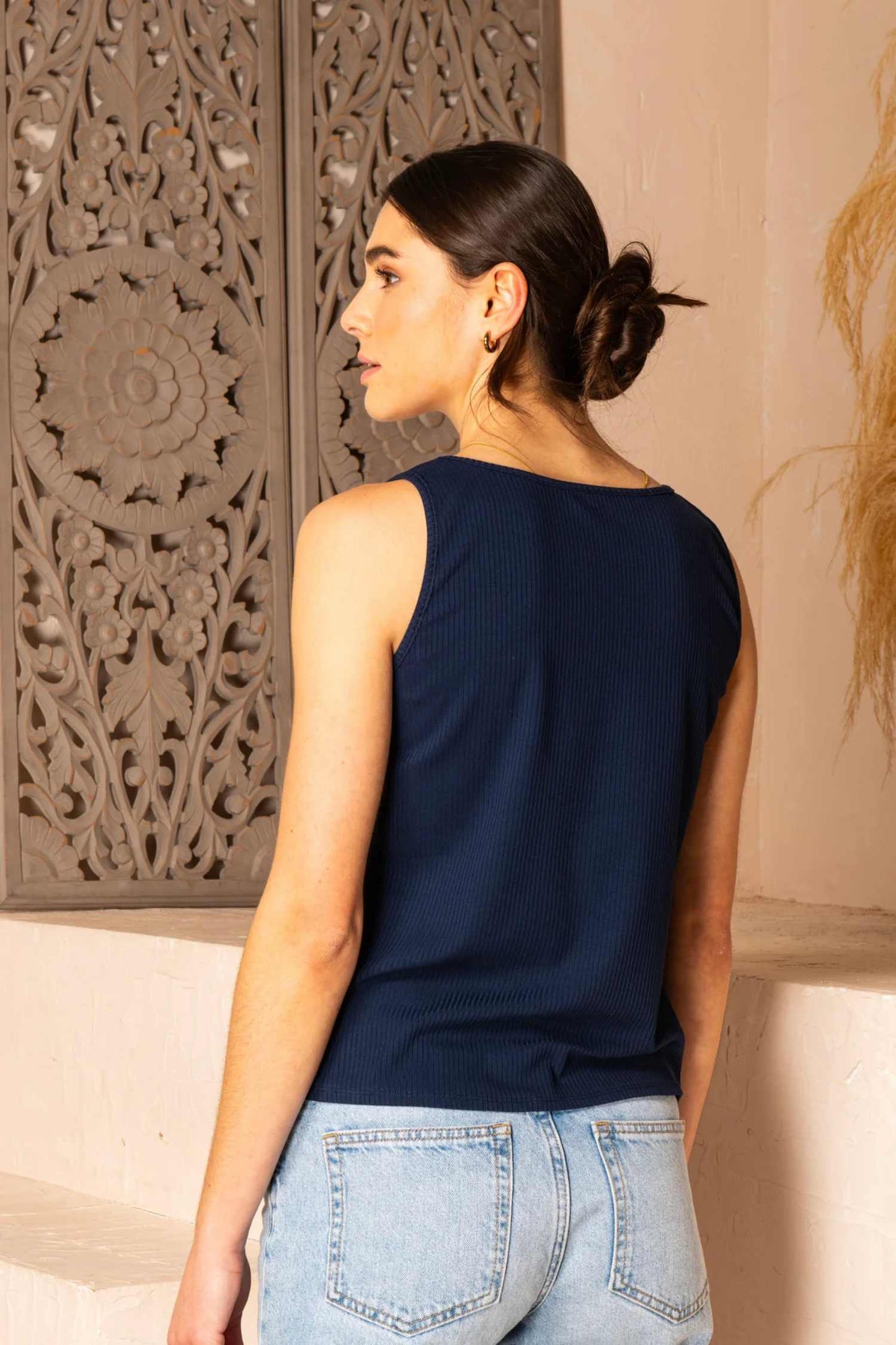 Back view close-up photo of a woman wearing the Aquarelle Cami by Cherry Bobin in Navy