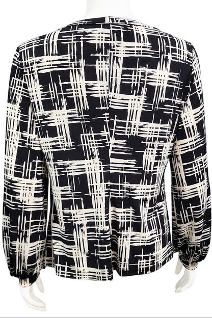 A back view of the Gwen Blouse by Mandala in Hopscotch - Black print is shown on a mannequin against a white background.