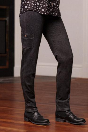 A waist-down view of a woman wearing the Goya Pants by Rien ne se Perd in Grey, faux-denim leggings with an elastic waistband and decorative side pockets. 