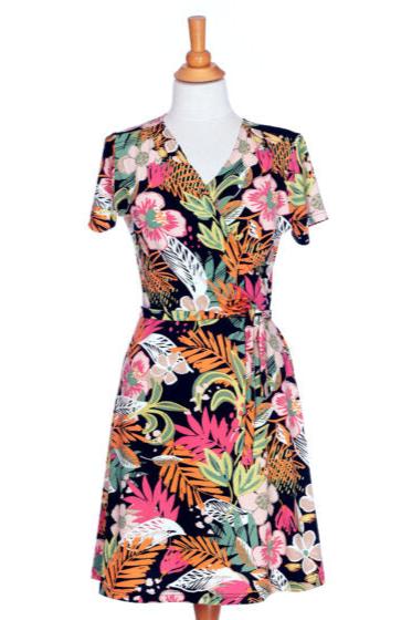 The back of the Macarena Dress by Rien ne se Perd in Tropical print, a short-sleeved faux-wrap dress with a drawstring waist and a flared above-the-knee skirt, is shown on a mannequin in front of a white background. 