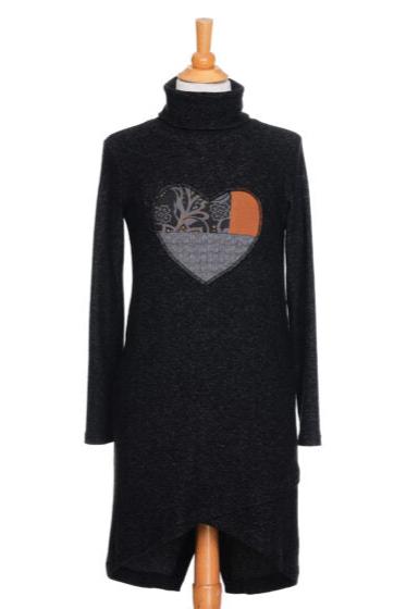 The Michelangelo Dress by Rien ne se Perd in Grey, a long sleeved turtleneck dress with a heart applique on the front, is shown on a mannequin in front of a white background. 