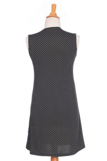 Samba Dress by Rien ne se Perd in Black and White Polka Dot, a sleeveless short dress with a V-neck, centre pleat, and side pockets, is shown on a mannequin in front of a white background. 