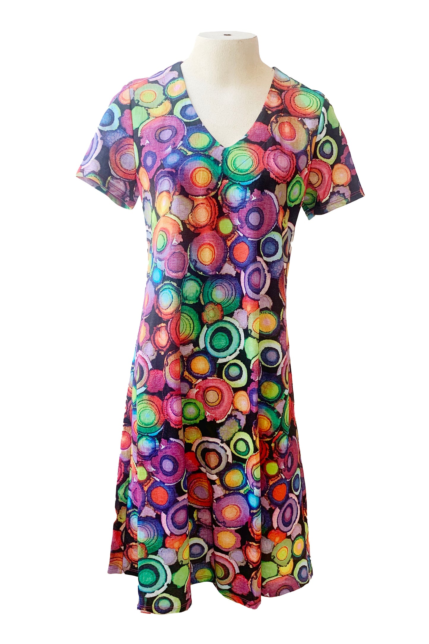 The Chase Dress by Pure Essence in a Multicolour circles print is shown on a mannequin in front of a white background 