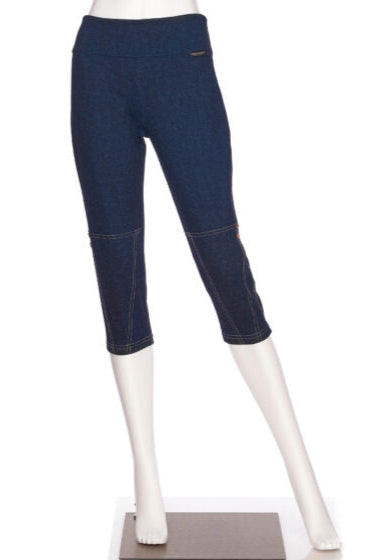 The Lindy Capri pants from Rien ne se Perd, faux denim stretch capris with a wide pull-on waist, contrast seams at the bottom, and decorative coconut buttons, are shown on a mannequin in front of a white background. 