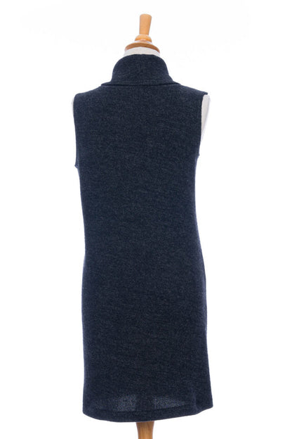 A back view of the long Baumier Vest by Rien ne se Perd in Charcoal, with a cowl neck, overlapping front, buttons and the shoulder and a patch pocket, is shown on a mannequin against a white background. 