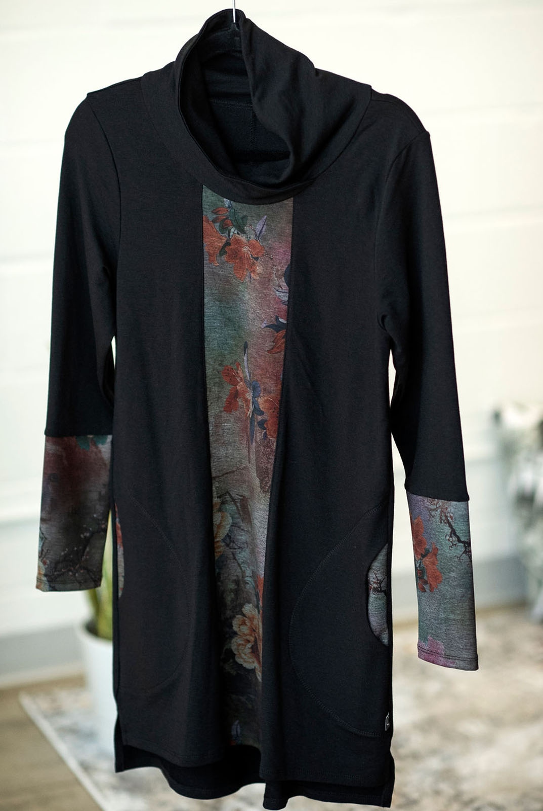 Honora Dress by Marie C, Black, cowl neck, long sleeves, contrasting floral fabric on front panel and sleeves, hi-low hemline, rounded inseam pockets, sizes XS to XL, made in Quebec