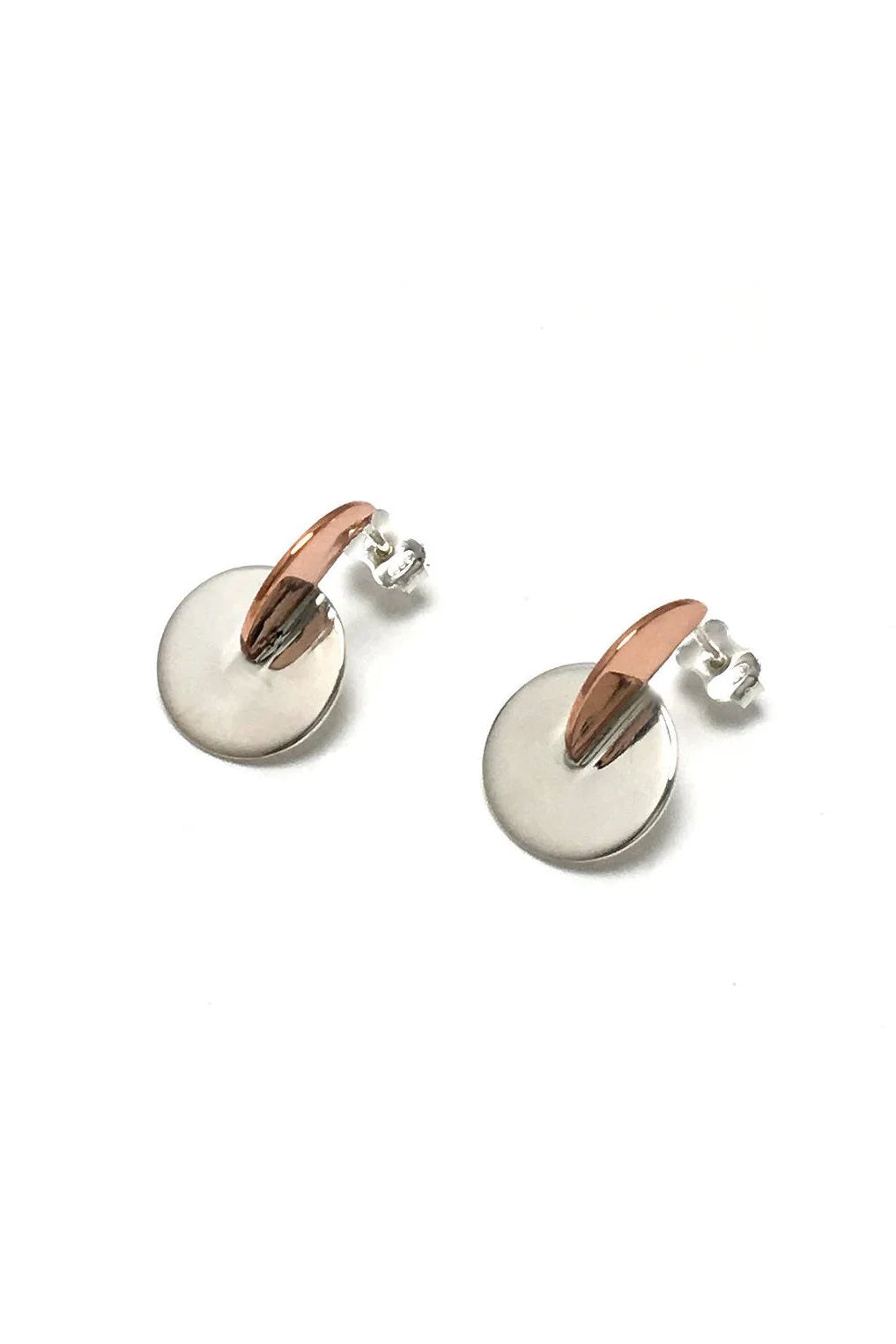 Claudine Moncion's Dem03 earerings in copper and sterling silver are shown on a white background