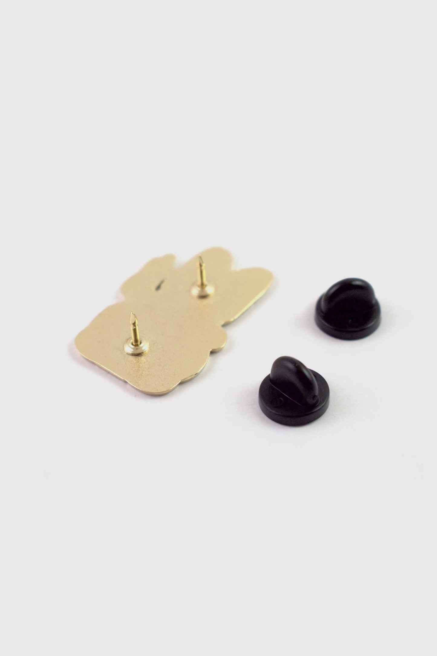 A back view of the Lucky Cat Pin from Badaboöm Studio, shown against a white background. 