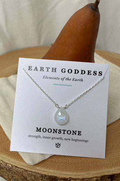 Moonstone necklace on a wooden stand with a 'Earth Goddess' card