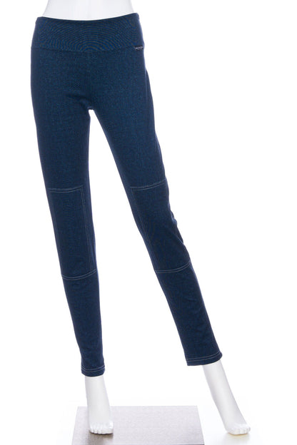 The Cypres Pants by Rien ne se Perd in Blue Denim, stretchy faux denim pants with a pull on waist and tone-on-tone patches on the knees, are shown on a mannequin in front of a white background. 