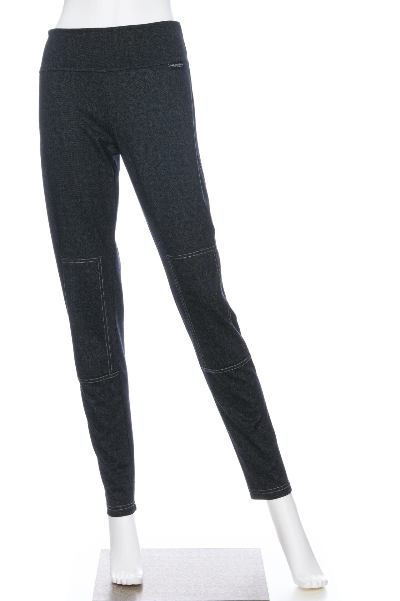 The Cypres Pants by Rien ne se Perd in Grey Denim, stretchy faux denim pants with a pull on waist and tone-on-tone patches on the knees, are shown on a mannequin in front of a white background. 