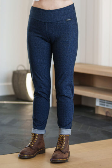 A waist down view of a woman A woman wearing the Granite Pants by Rien ne se Perd in Denim Blue, standing in an entry way