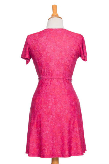 Selena Dress by Rien ne se Perd, Red Hearts, back view, wrap dress, faux-wrap neckline, short sleeves, tie at waist, fit and flare shape, above the knee, sizes XS to XXL, made in Quebec 